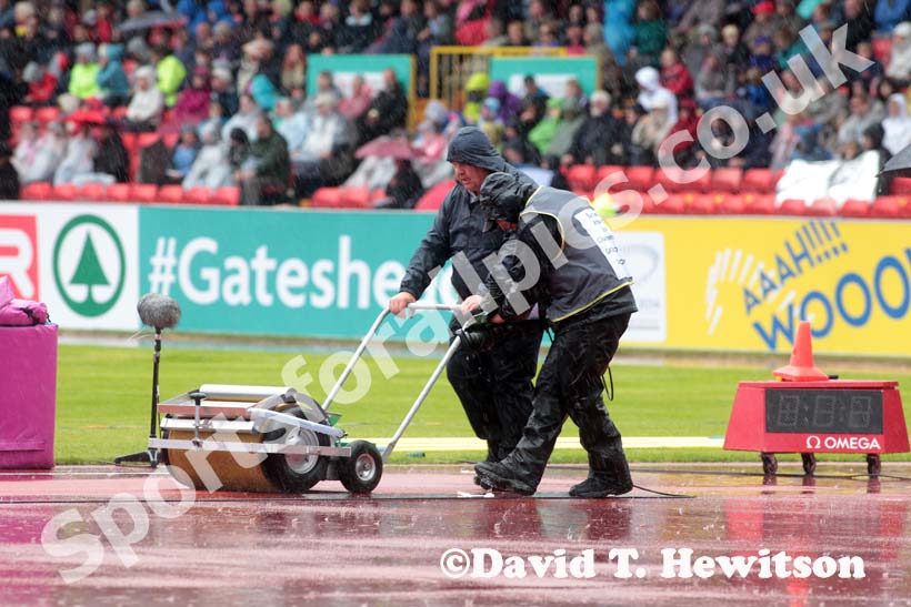 Clearing away the water while being filmed at the European Athletics Team Championships.